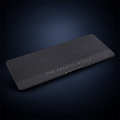Studio concept image of a wide dark textured founder desk mat with The Kreativ Block branding along its lower edge.